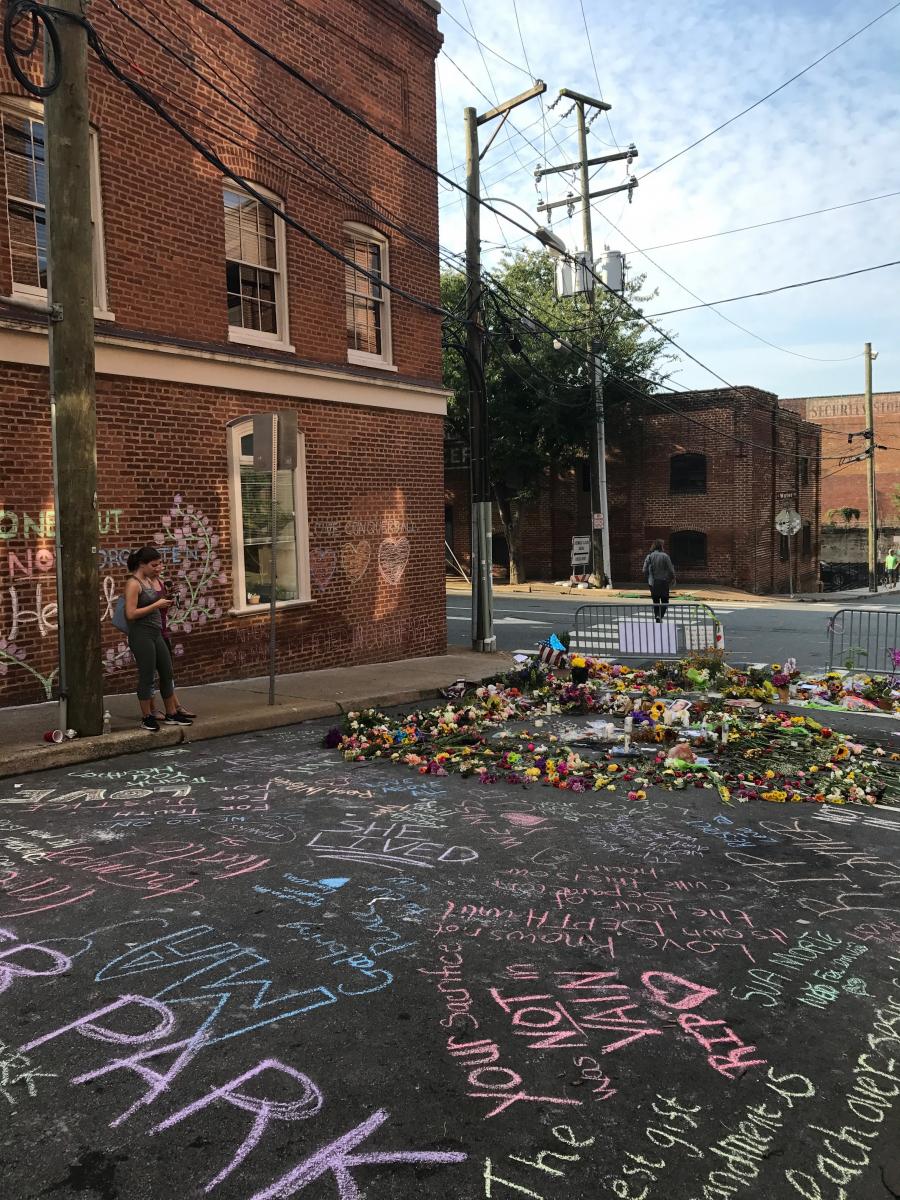 Anne Scott, president and CEO of the Charlottesville Area Foundation shared a photo of the growing memorial outside her office where Heather Heyer was killed while protesting against white supremacists.